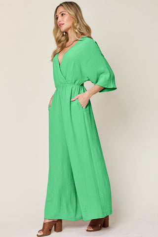 Shop Mid Green Double Take Full Size Surplice Wide Leg Jumpsuit with Pockets - High-Quality U.S. Made Women’s Fashion with Free & Fast Shipping