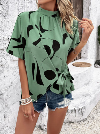 Shop Tied Printed Mock Neck Half Sleeve Blouse Now On Klozey Store - Trendy U.S. Premium Women Apparel & Accessories And Be Up-To-Fashion!